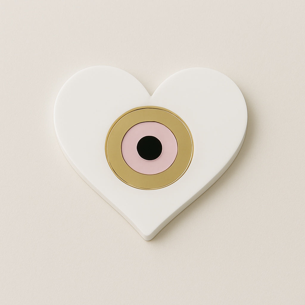 Heart-shaped white plexiglass charm with pink and gold evil eye detail So Cute Cut
