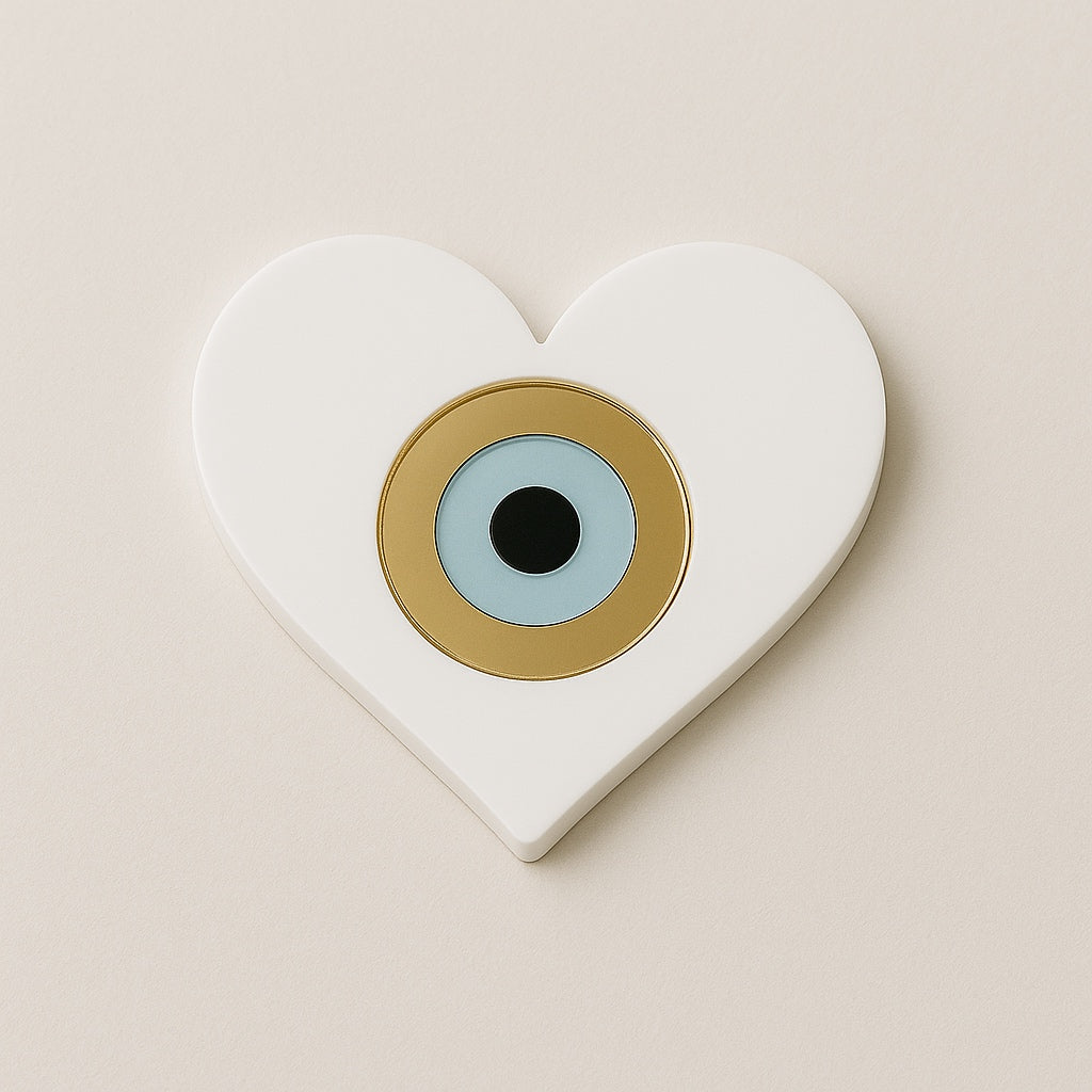 Heart-shaped white plexiglass charm with blue and gold evil eye detail - So Cute Cut