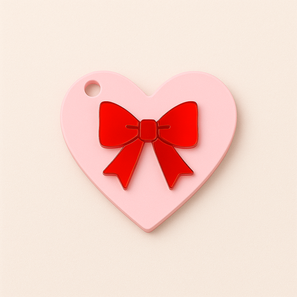 Heart-shaped plexiglass charm with red mirror appliqué bow, 8cm, for bag charm or keychain.