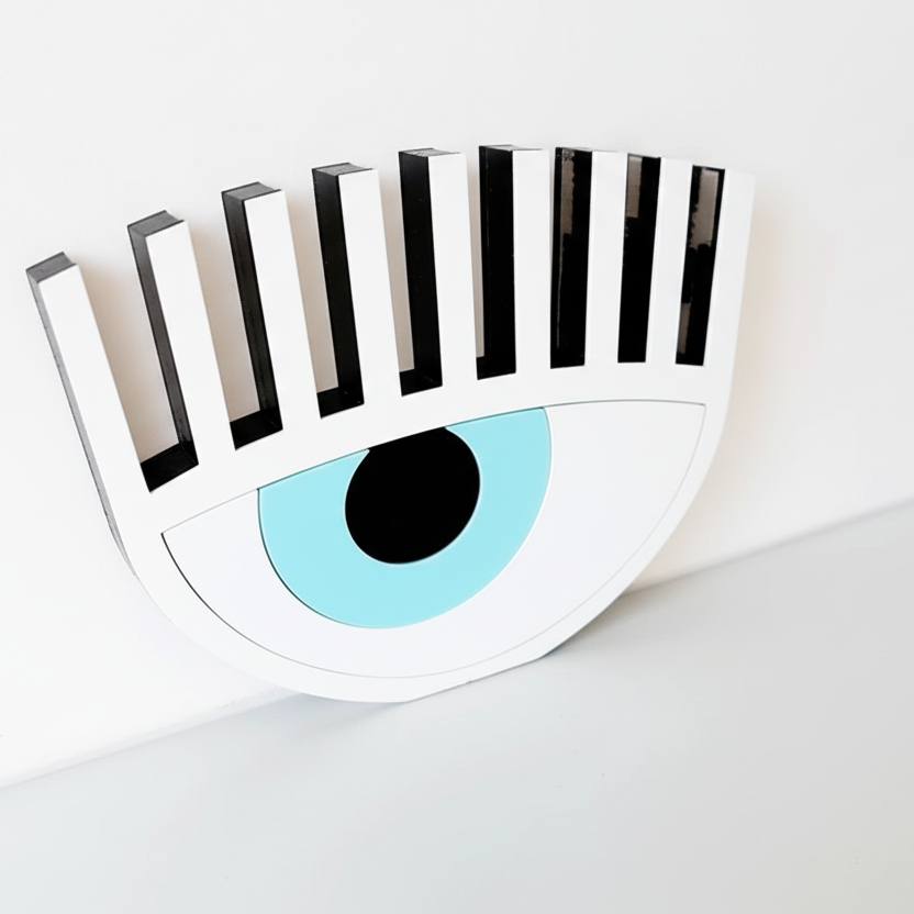 Handmade white plexiglass evil eye table charm with lashes on neutral background – So Cute by Dimi.