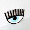 Handmade black plexiglass evil eye table charm with lashes on neutral background – So Cute by Dimi.