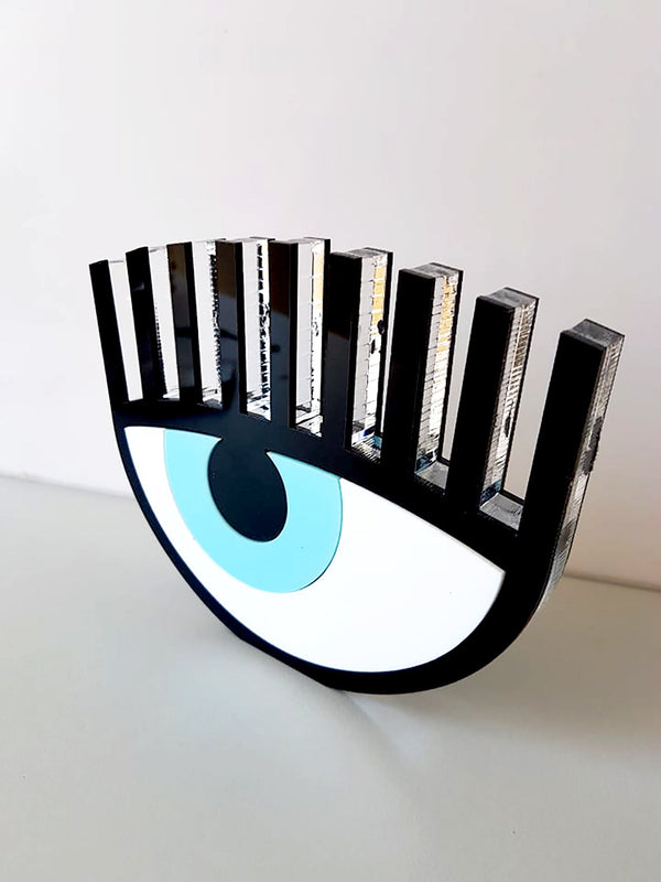 Handmade black plexiglass evil eye table charm with lashes on neutral background – So Cute by Dimi.