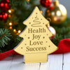 Decorative Christmas tree-shaped acrylic plaque engraved with “Health, Joy, Love, Success” and minimalist festive graphics – So Cute Cut corporate gift.

