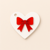 Heart-shaped plexiglass charm with red mirror appliqué bow, 8cm, for bag charm or keychain.
